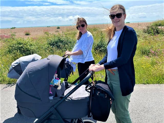 Two mums pushing prams outdoors