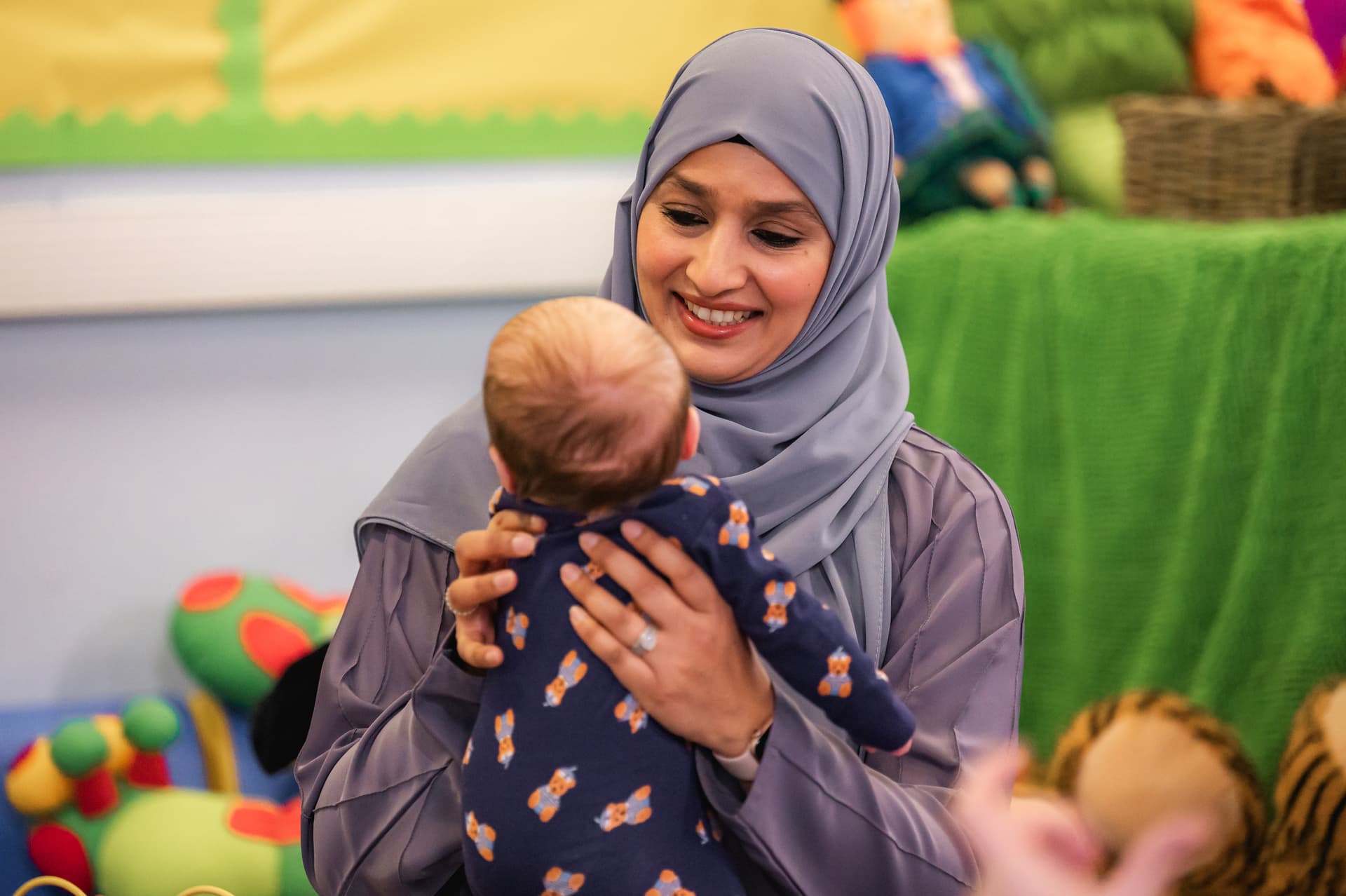 Peer holding a baby